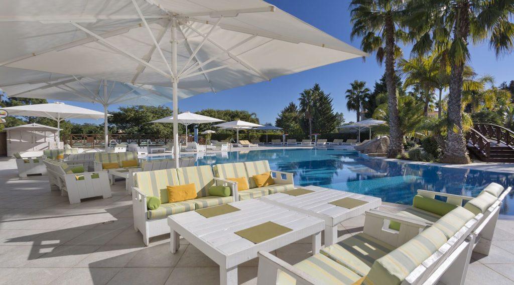 Outdoor patio furniture next to a hotel pool