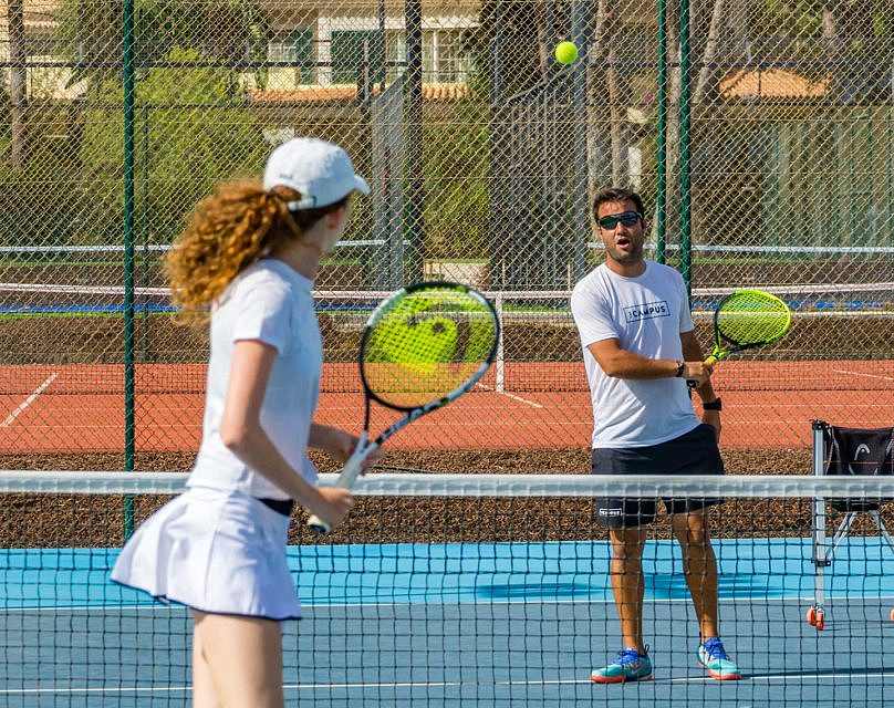 Couple playing tennis on a court
