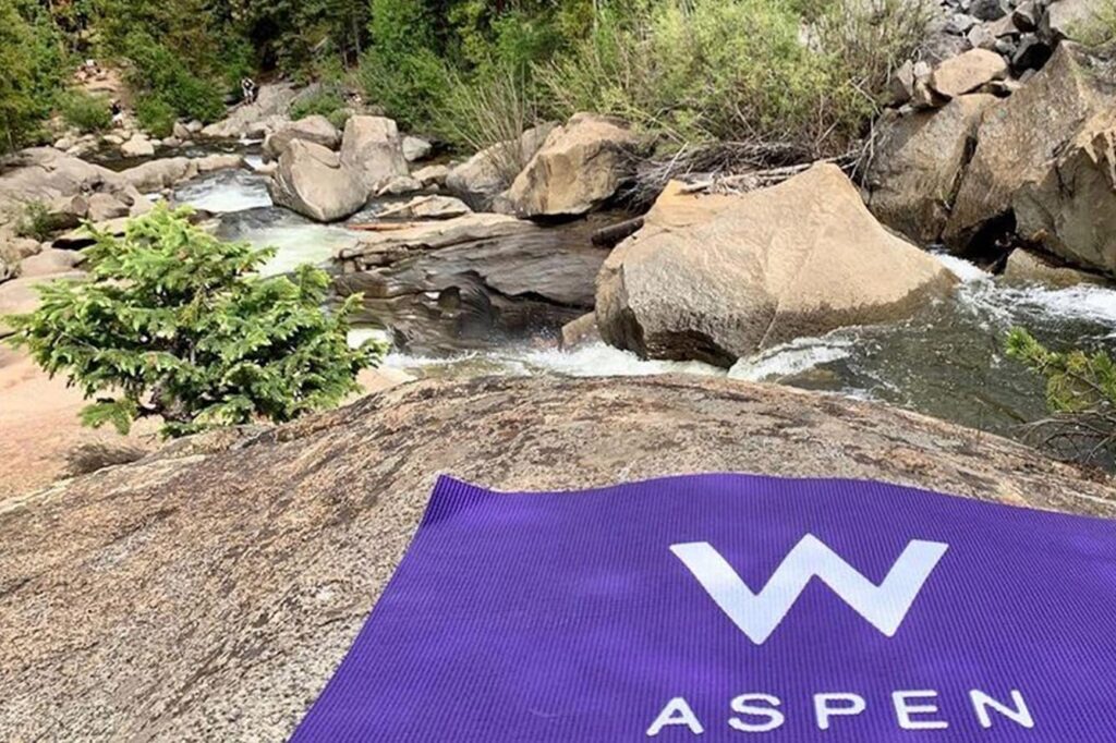 Yoga mat placed next to a stream in Aspen