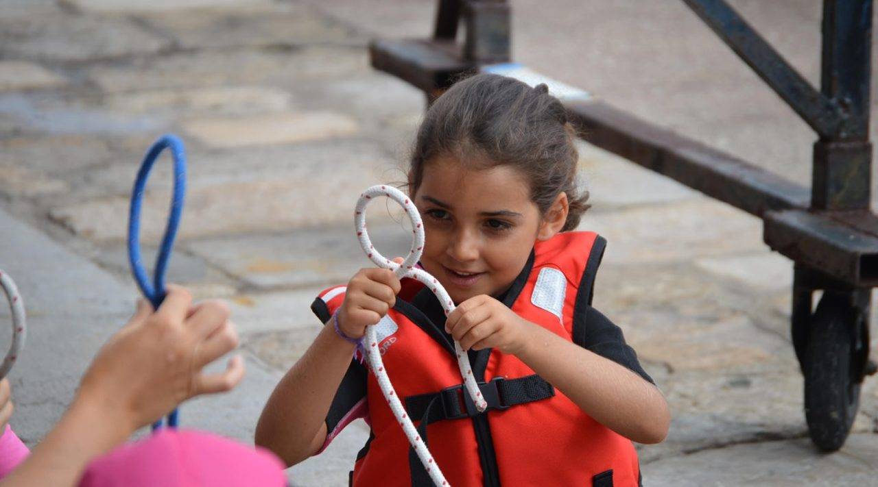 Young girl tying a sailors knot