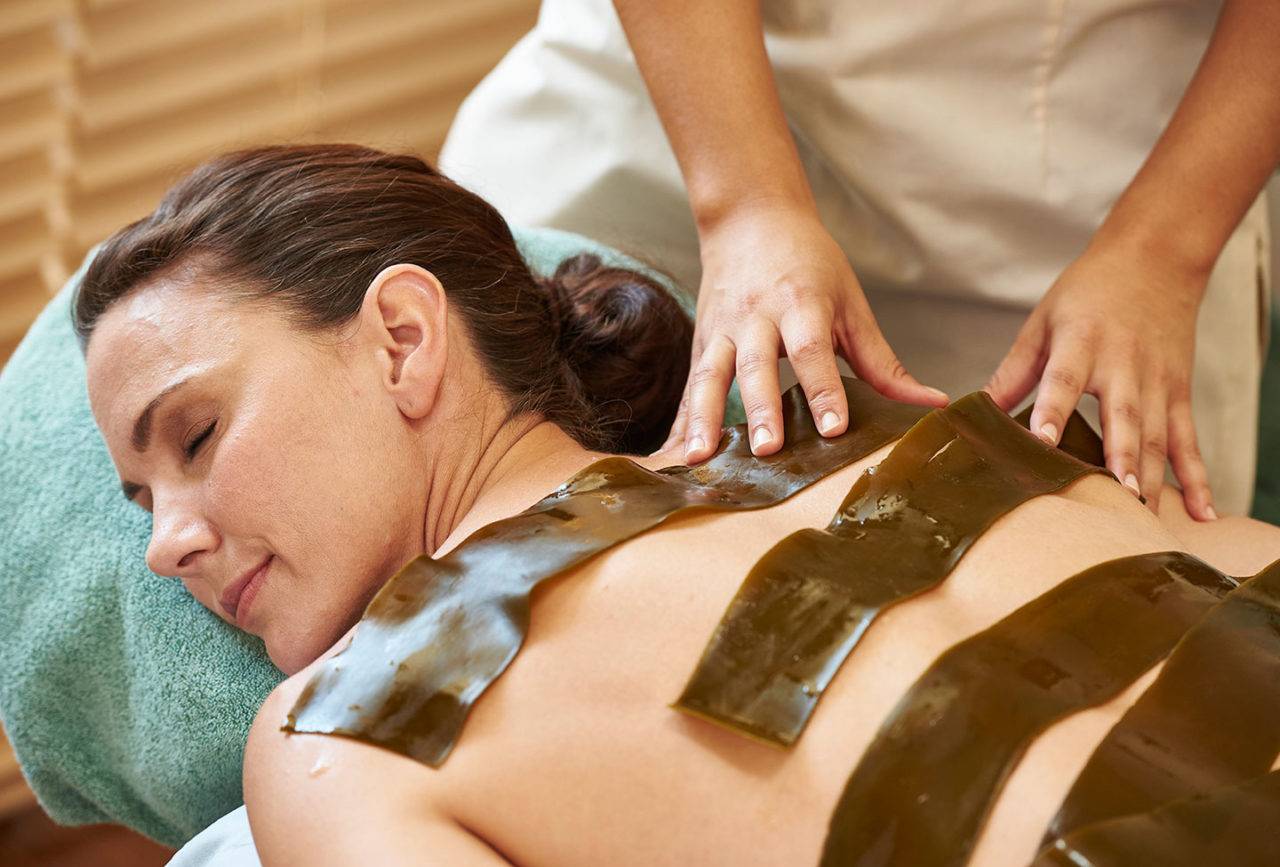 Woman getting a wrap treatment at a spa