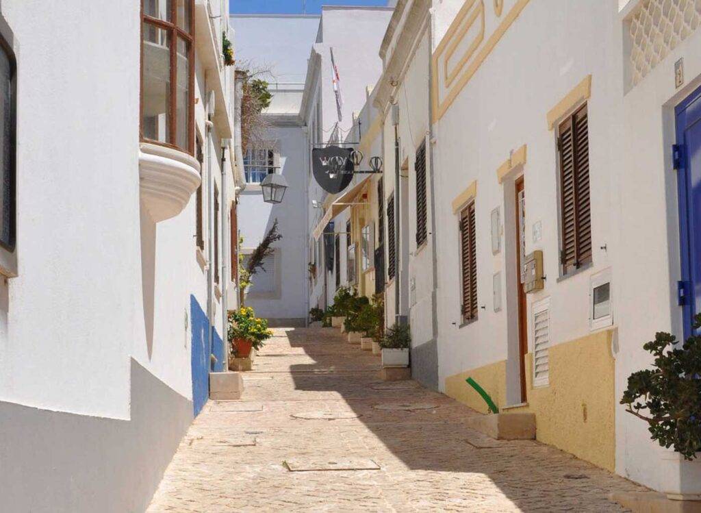 Cobblestone lined historic village street in Algrave, Portugal