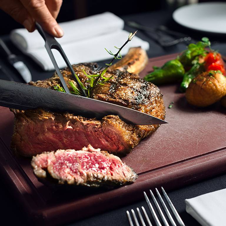 Slicing a steak on a cutting board