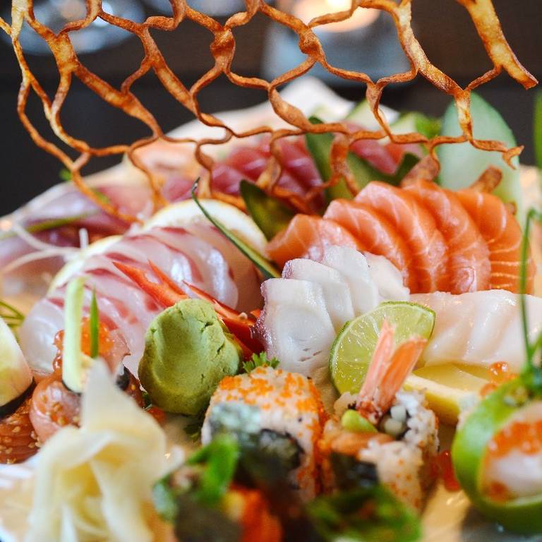 Plated sushi and raw fish slices at Yakuza by Olivier restaurant