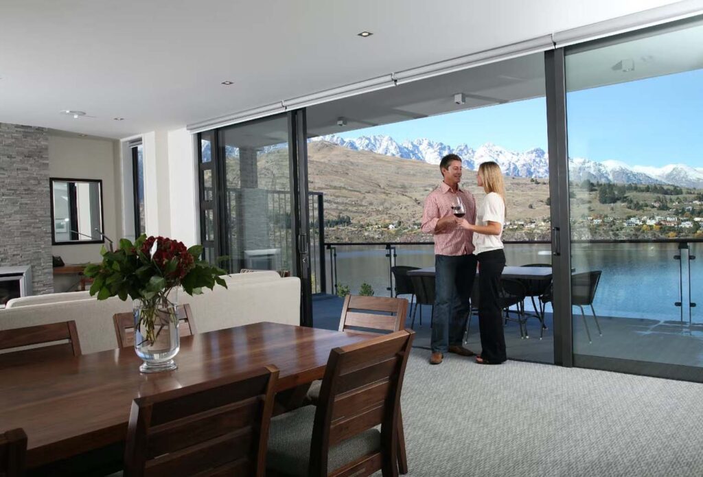 Couple drinking wine on a balcony at the Rees Hotel, New Zealand