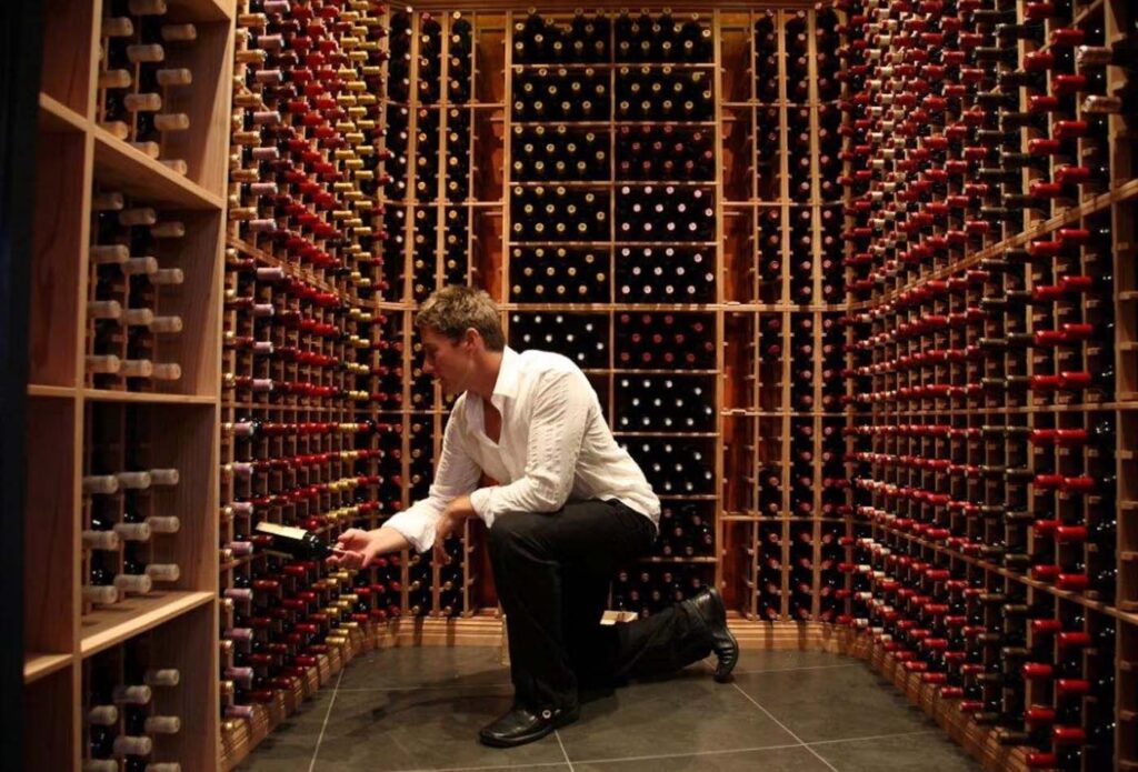 Sommelier selecting wine at the Rees Hotel, New Zealand