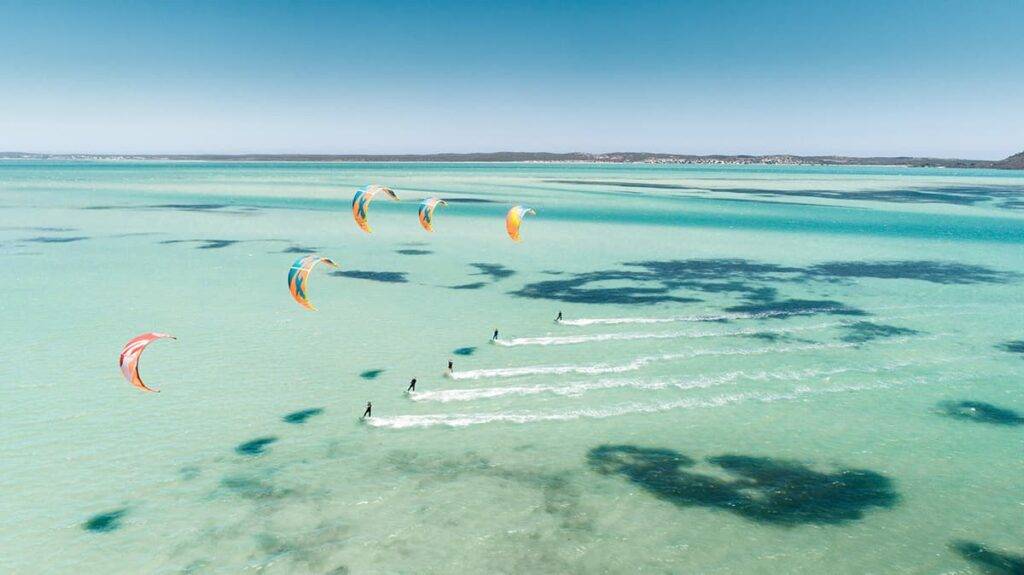 Group of people kite boarding in the Caribbean Sea