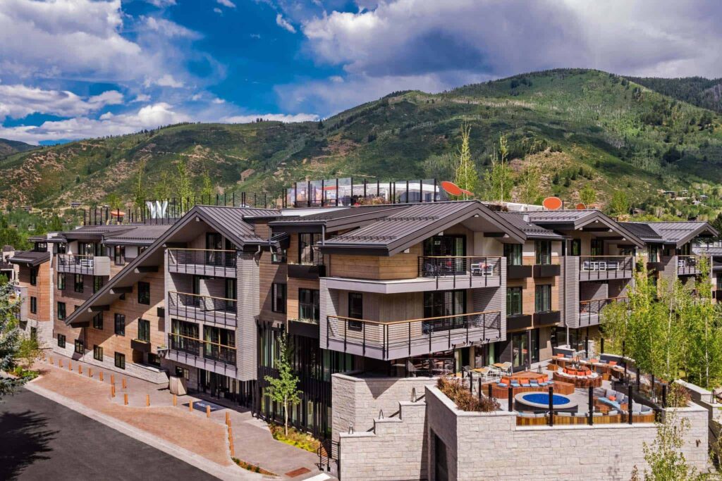 A place to stay at The Sky Residences at W Aspen exterior surrounded by lush green mountains.