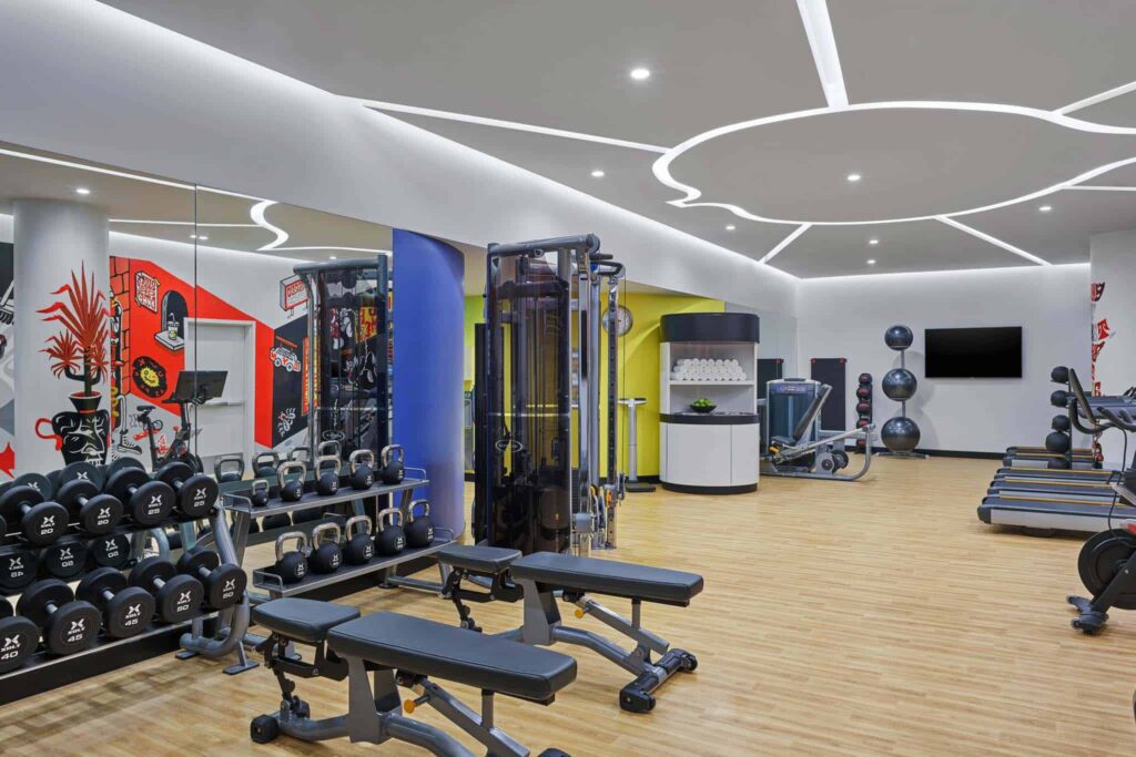 Sky Residences at W Aspen fitness center with workout equipment, weights, and treadmills.