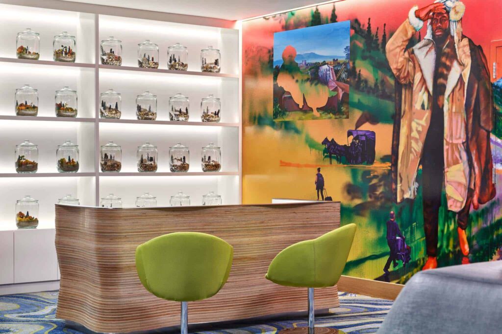 Sky Residences at W Aspen lobby welcome desk with Aspen history-inspired wall mural.
