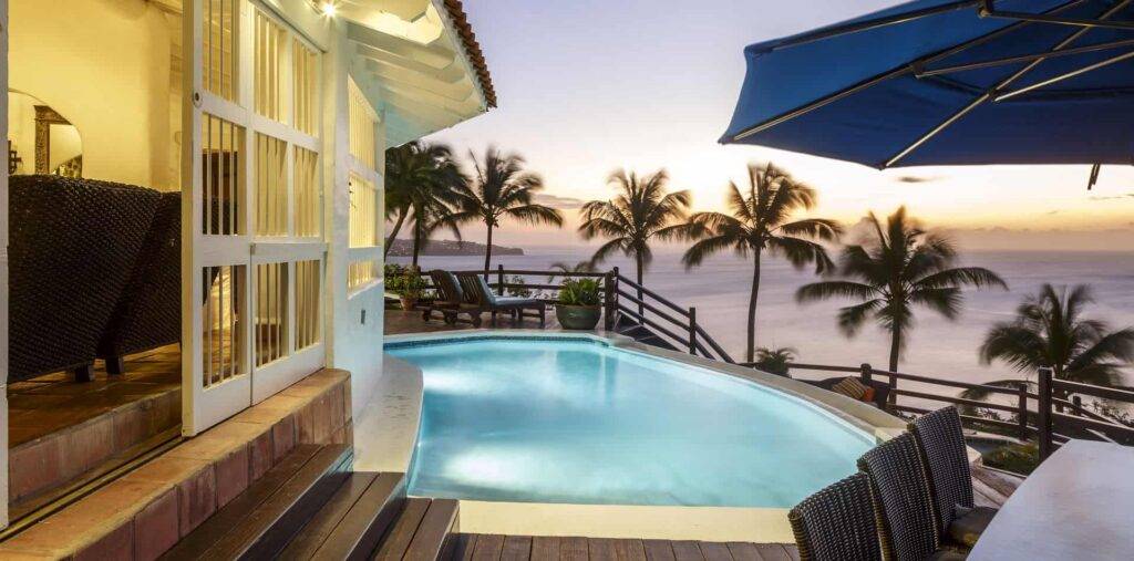 Windjammer Landing 5-bedroom villa with outdoor pool lit at sunset.