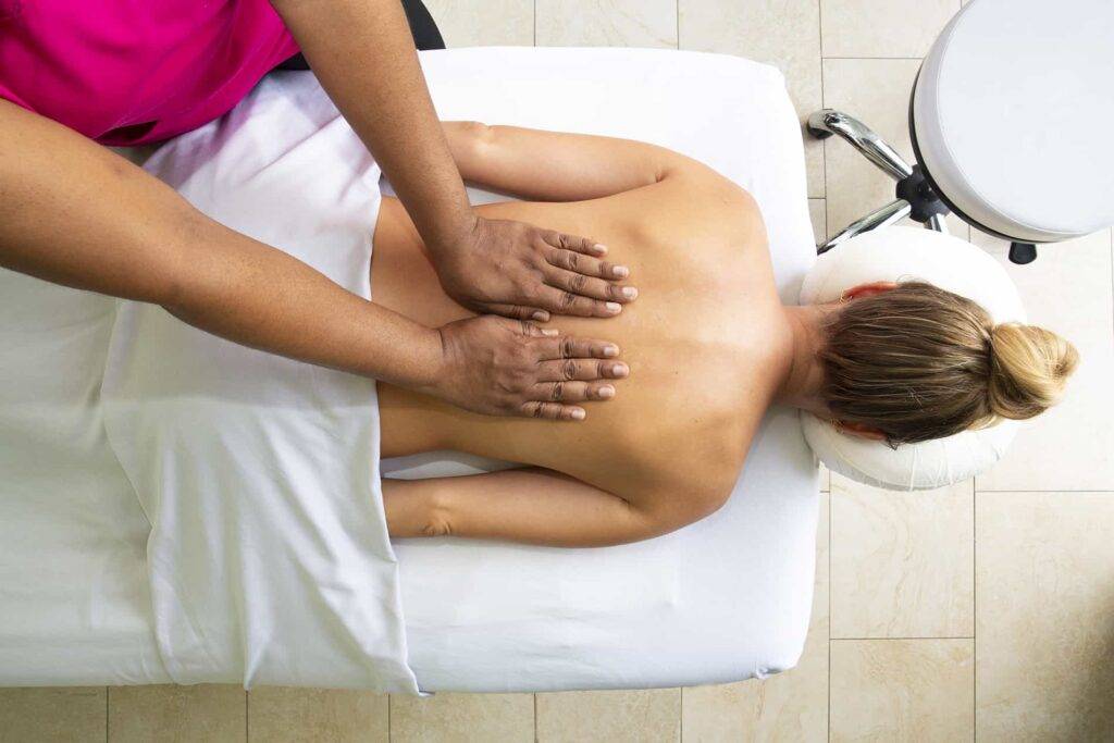 Woman receiving a back massage at the Windjammer Landing spa