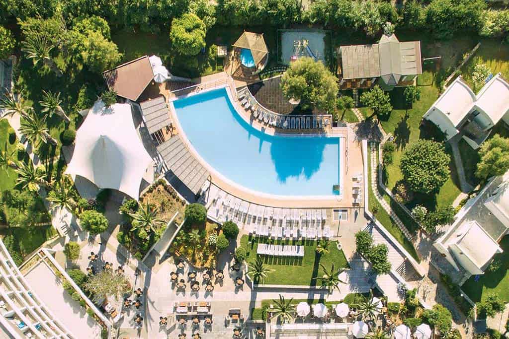 Outdoor pool and lounge chairs at the Agapi Beach Resort