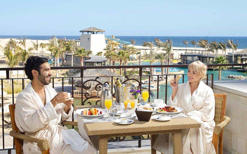 Couple eating breakfast on a balcony at Grand Solmar at Rancho San Lucas Resort