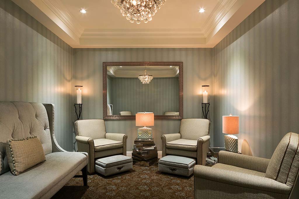 Spa lounge with comfortable seating and soothing lighting.