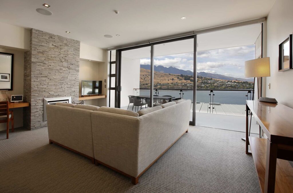 Executive Lake View 3 Bedroom Apartment living room with fireplace and balcony