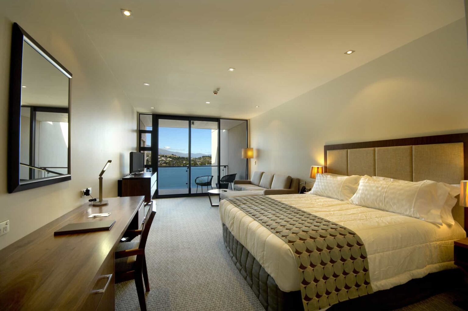 Executive Lake View Hotel Room with large king bed and balcony