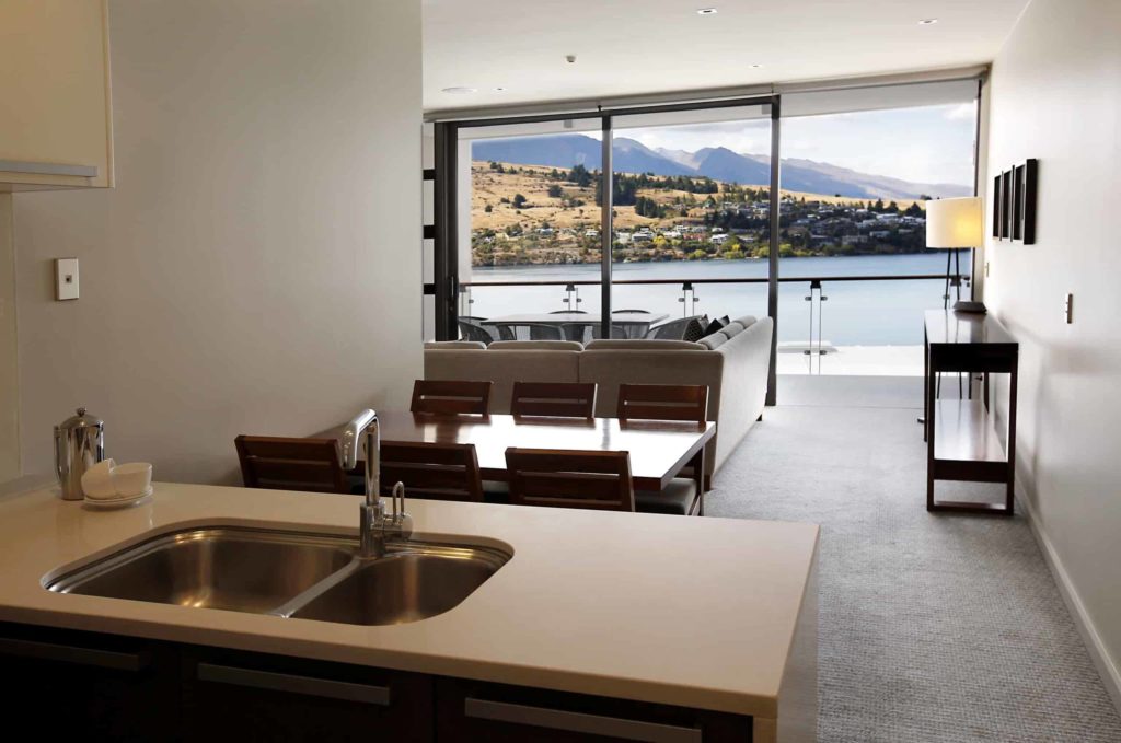 Cocina, comedor y sala de estar con acceso al balcón: Apartamento de 3 habitaciones con vista al lago