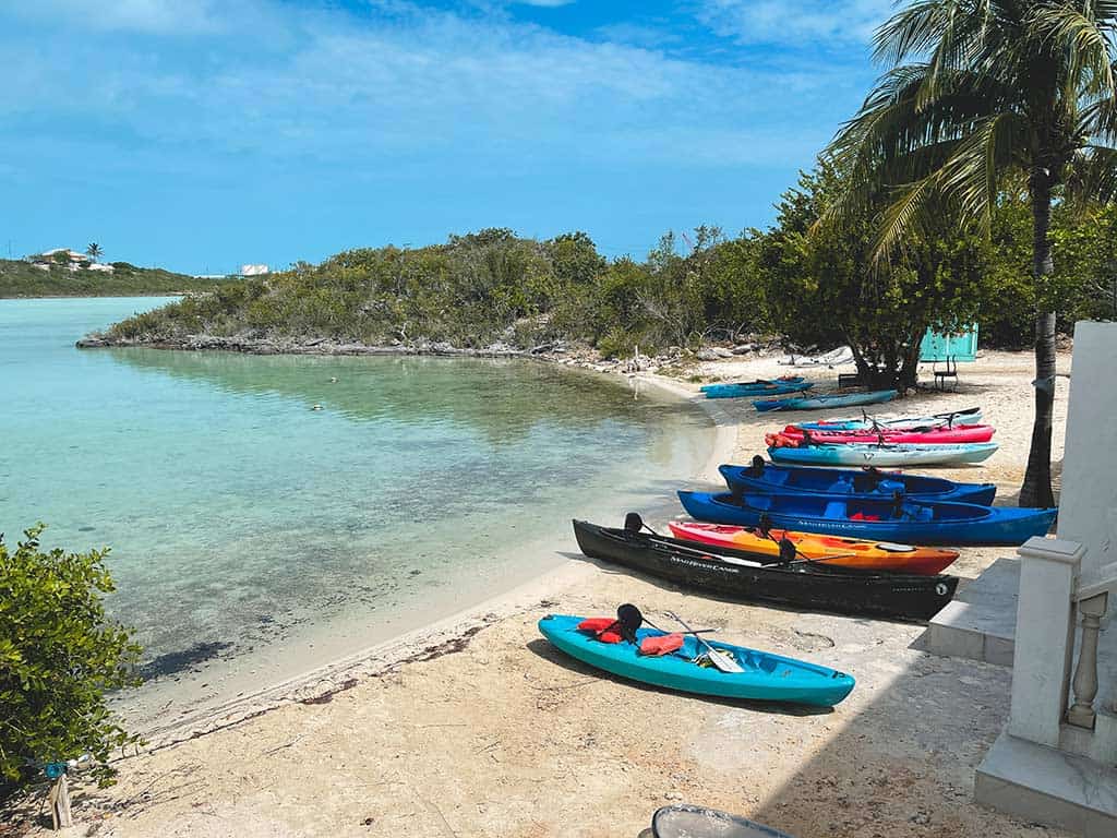 Kayaks and canoes lined up on a beach in Turks & Caicos.