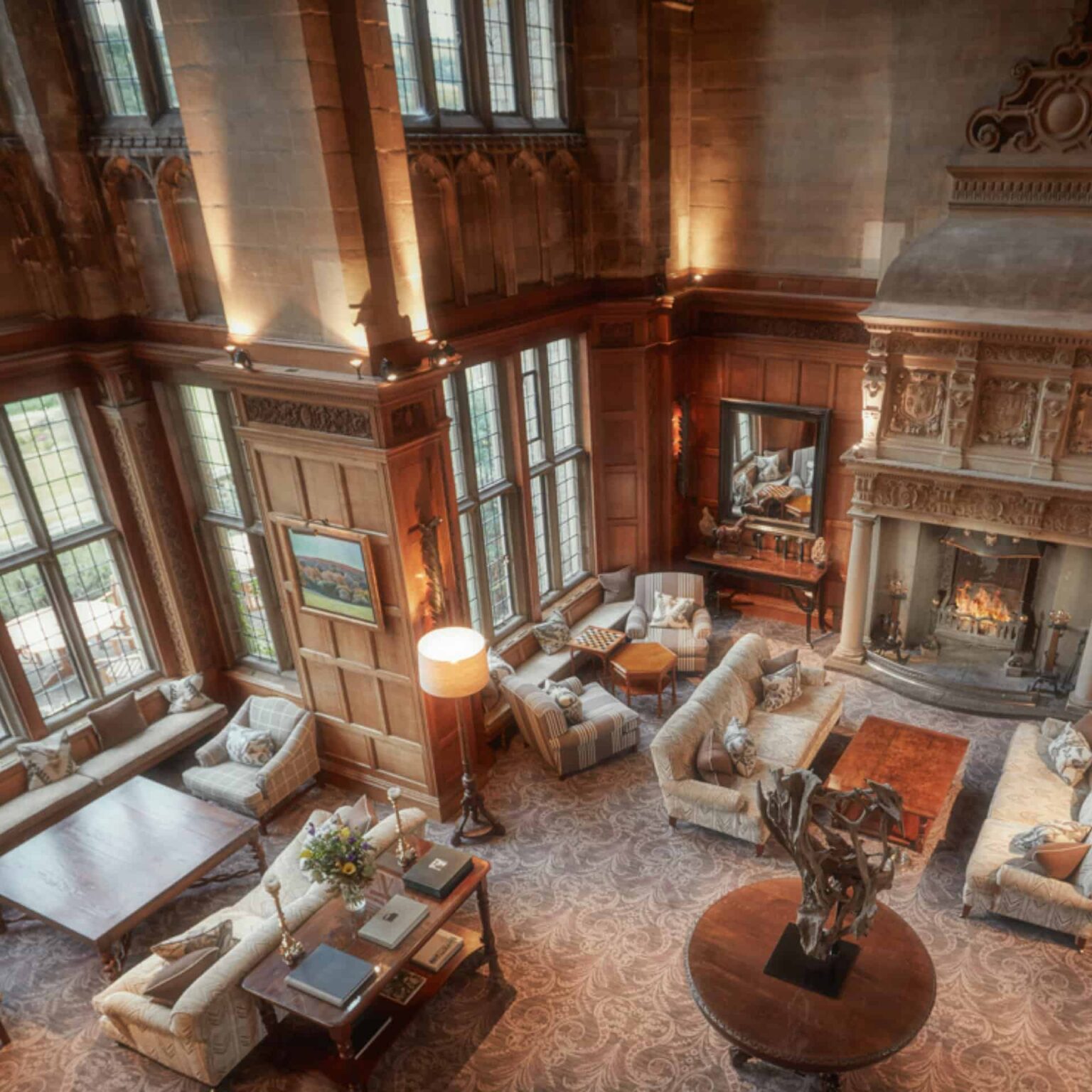 Bovey Castle interior grand living room with high ceiling and fireplace