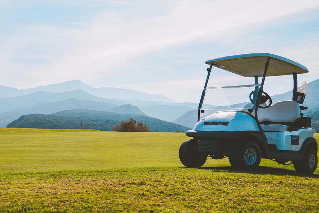 Golf cart on a course with mountains in the background | Crete, Greece
