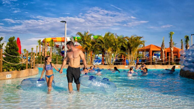 Father and daughter walking in a pool at Island H2O Water Park.