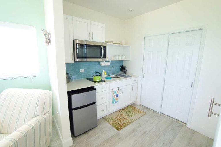 Blue Iguana guest room kitchenette with mini fridge, microwave, coffee maker, toaster, and tea kettle