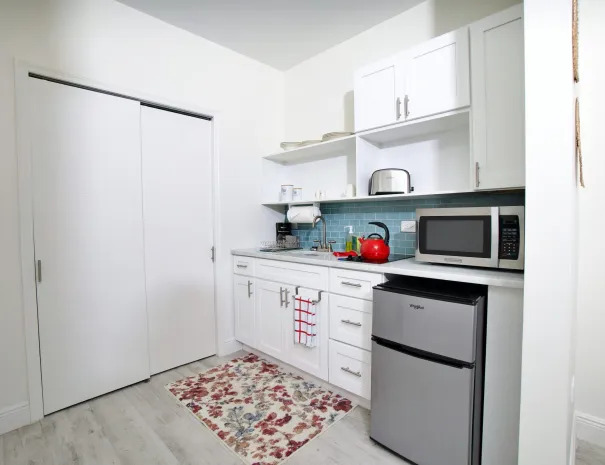 No Problem guest room kitchenette with a mini fridge, microwave, and toaster