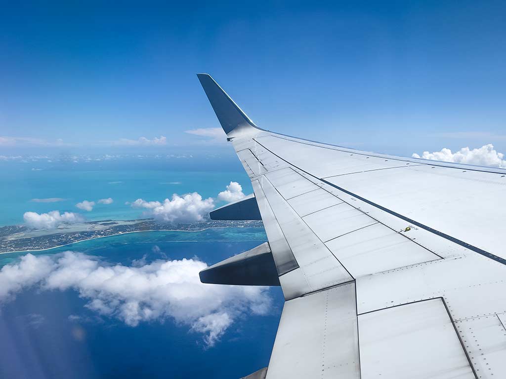 View of an airplane wing in flight above Turks & Caicos.