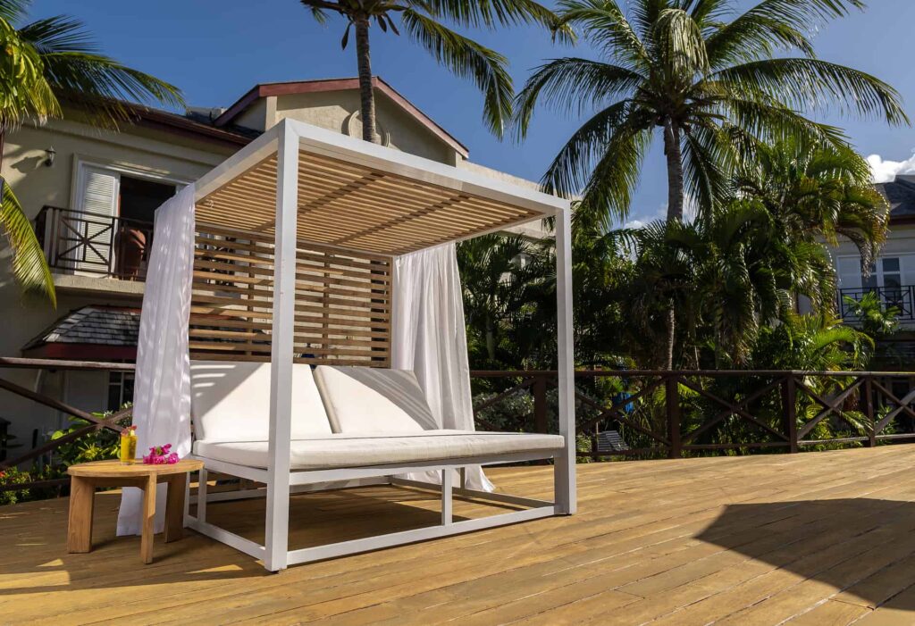 Cap Cove Resort poolside cabana with side table set with a tropical drink