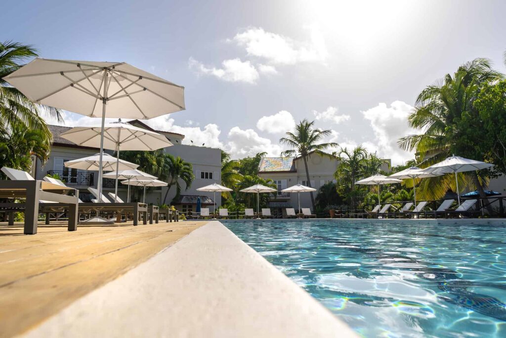 Cap Cove Resort pool edge with panoramic view of surrounding sun loungers