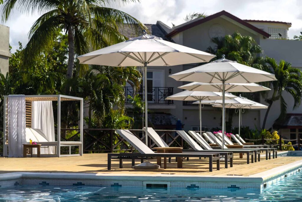Cap Cove Resort pool with sun loungers and cabana