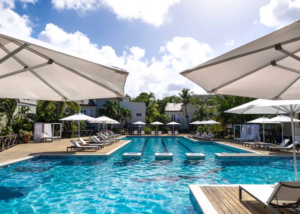 Cap Cove Resort pool surrounded by sun loungers and umbrellas