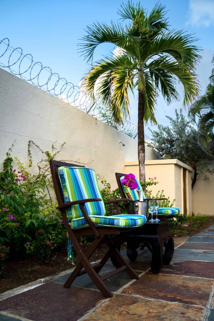 Cap Cove Resort private backyard folding chairs next to a side table with chilled champagne.