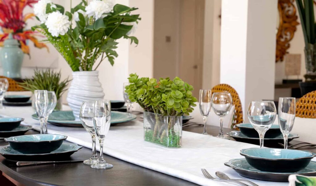 4 Bedroom Villa: Dining room glassware and decorative flowers in a vase.
