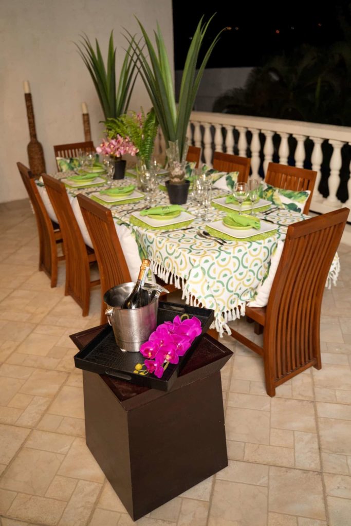 4 Bedroom Villa: Covered balcony with dining table set for dinner outdoors