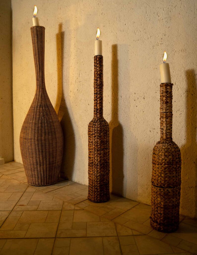 Lit candles in wicker stands on an outdoor balcony at a 4 Bedroom Villa