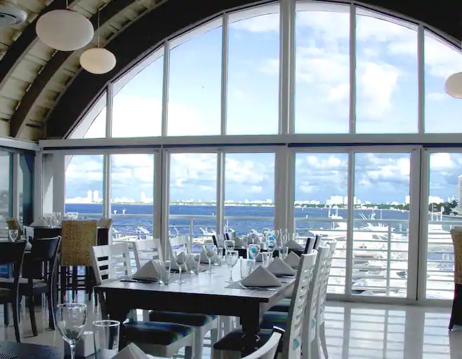 Casablanca on the Bay restaurant tables and chairs overlooking a marina at the Grand Hotel Biscayne Bay
