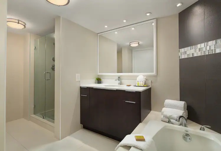 Bathroom shower, tub, and vanity at Grand Hotel Biscayne Bay