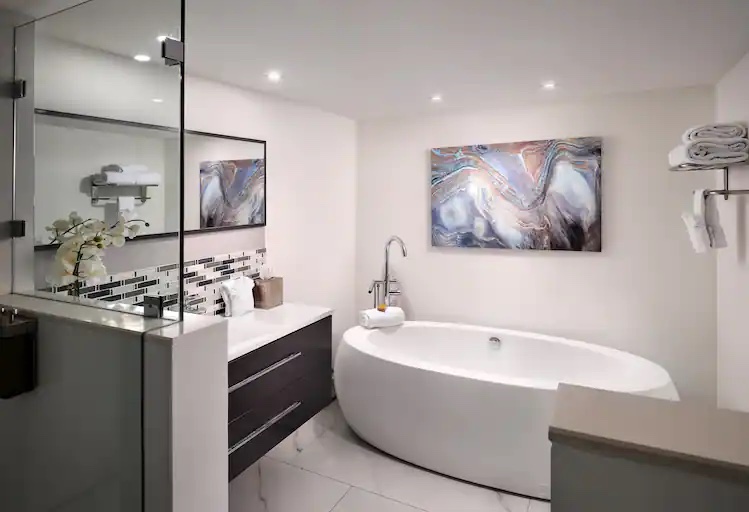 Bathroom shower, vanity, and tub at Grand Hotel Biscayne Bay