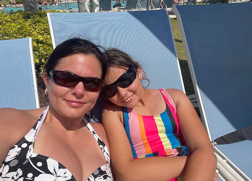 Mother and daughter relaxing in lounge chairs