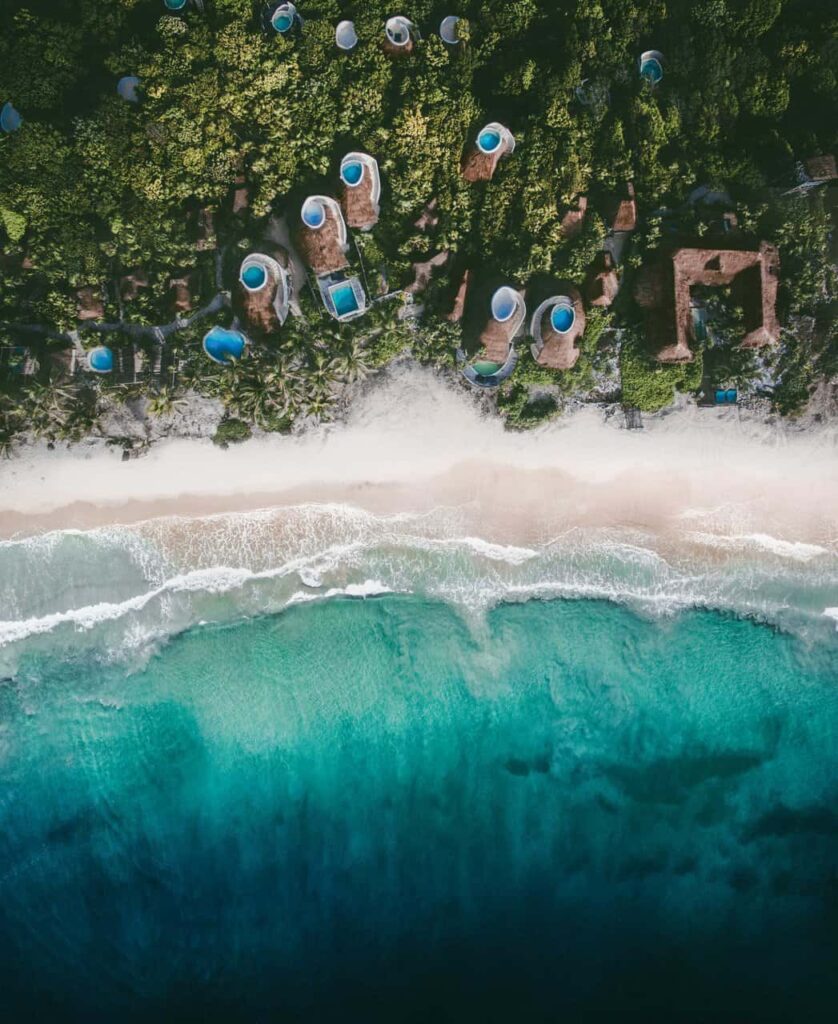 Aerial view of Papaya Playa Project beach and ocean view casitas.