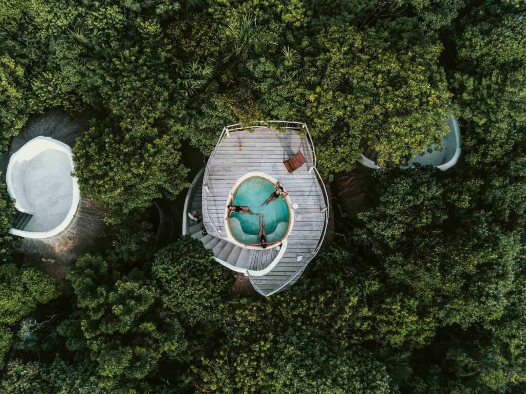 Bird’s eye view of women relaxing in a dipping pool at a Papaya Playa Project ocean view casita.