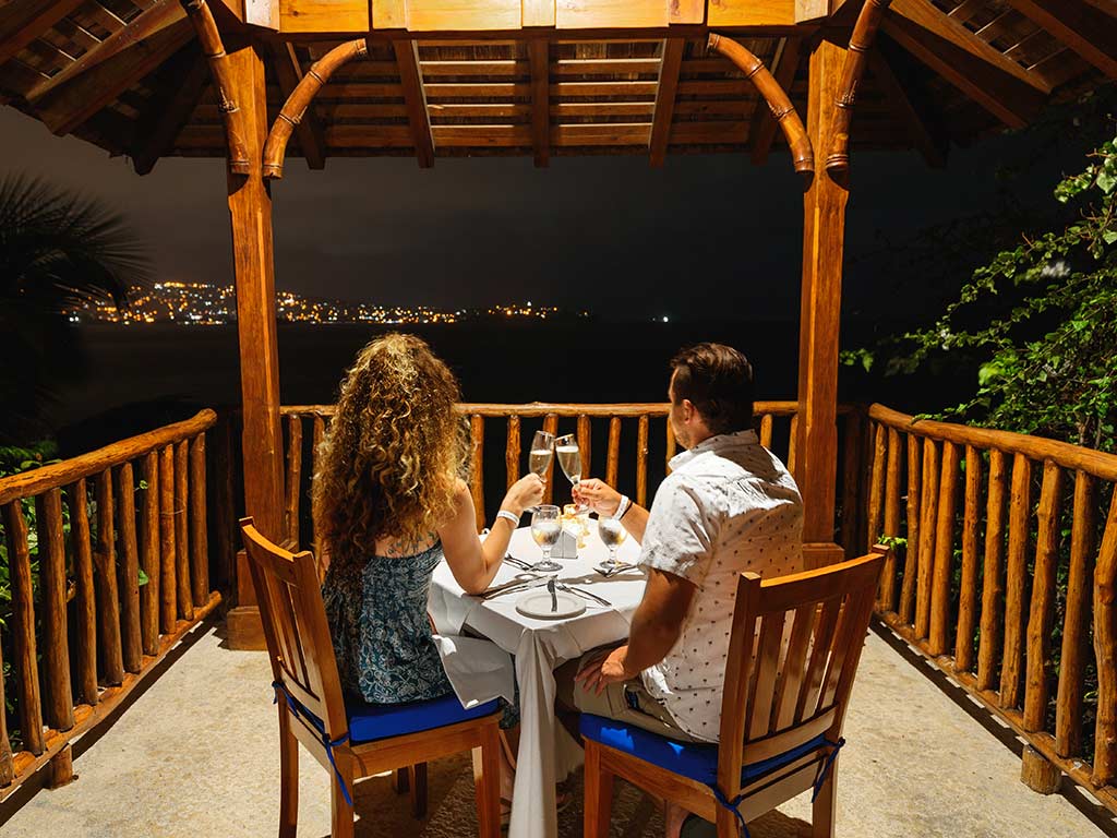 Couple enjoying a private meal in an outdoor gazebo