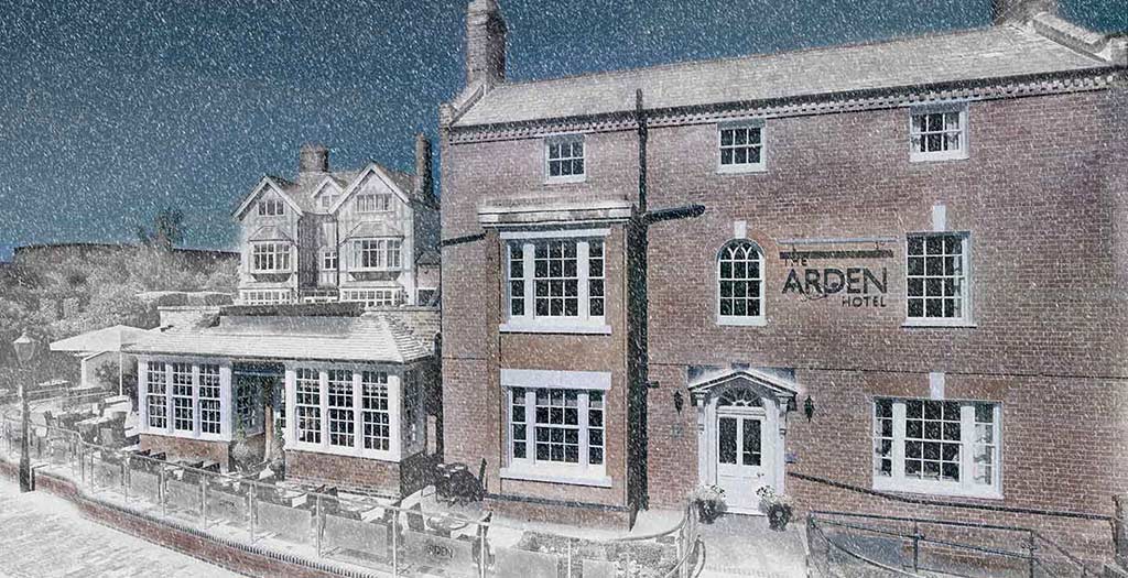 Exterior view of the Arden Hotel during a snowfall