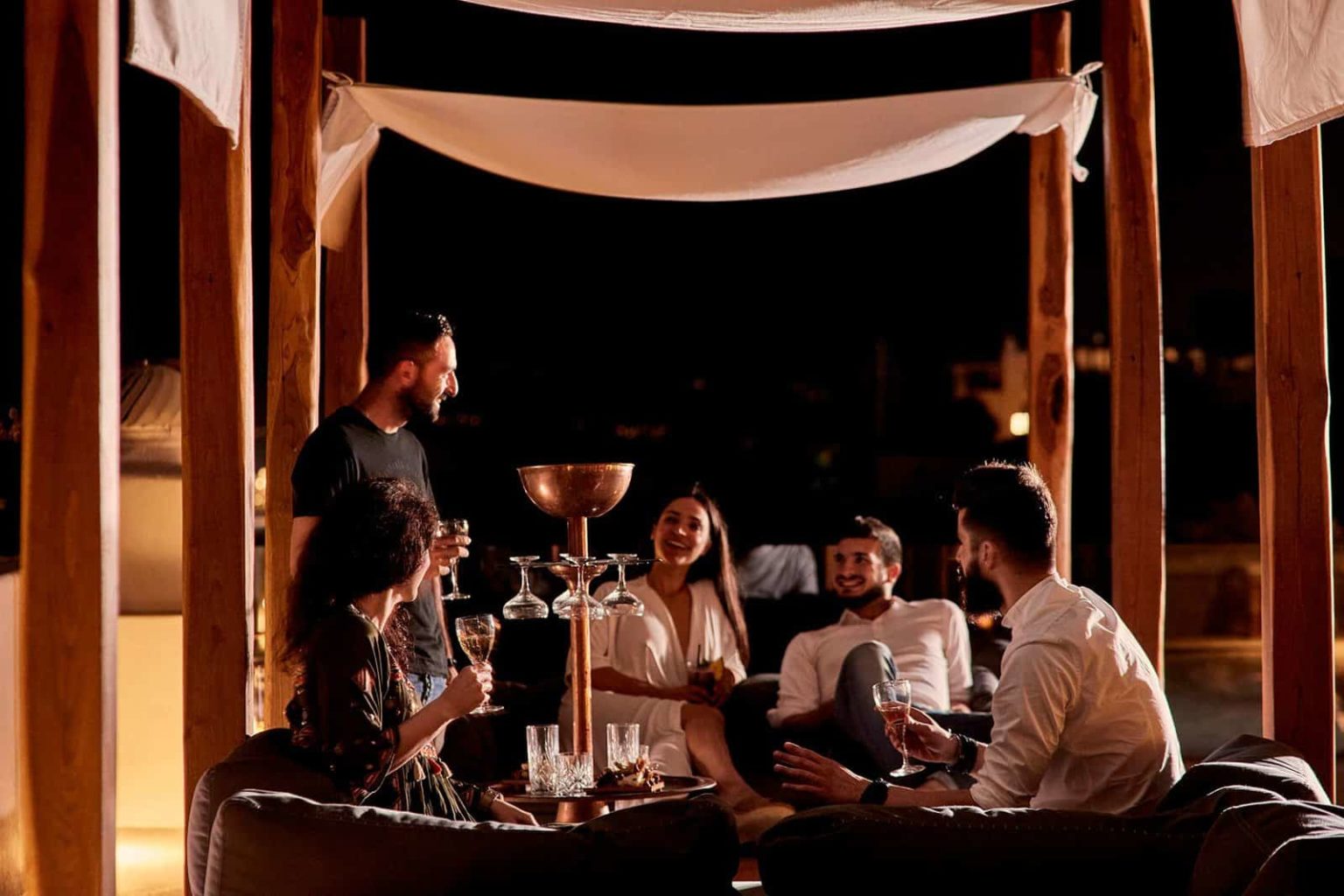 Group of people enjoying cocktails at Bilo Bar - Boheme Mykonos