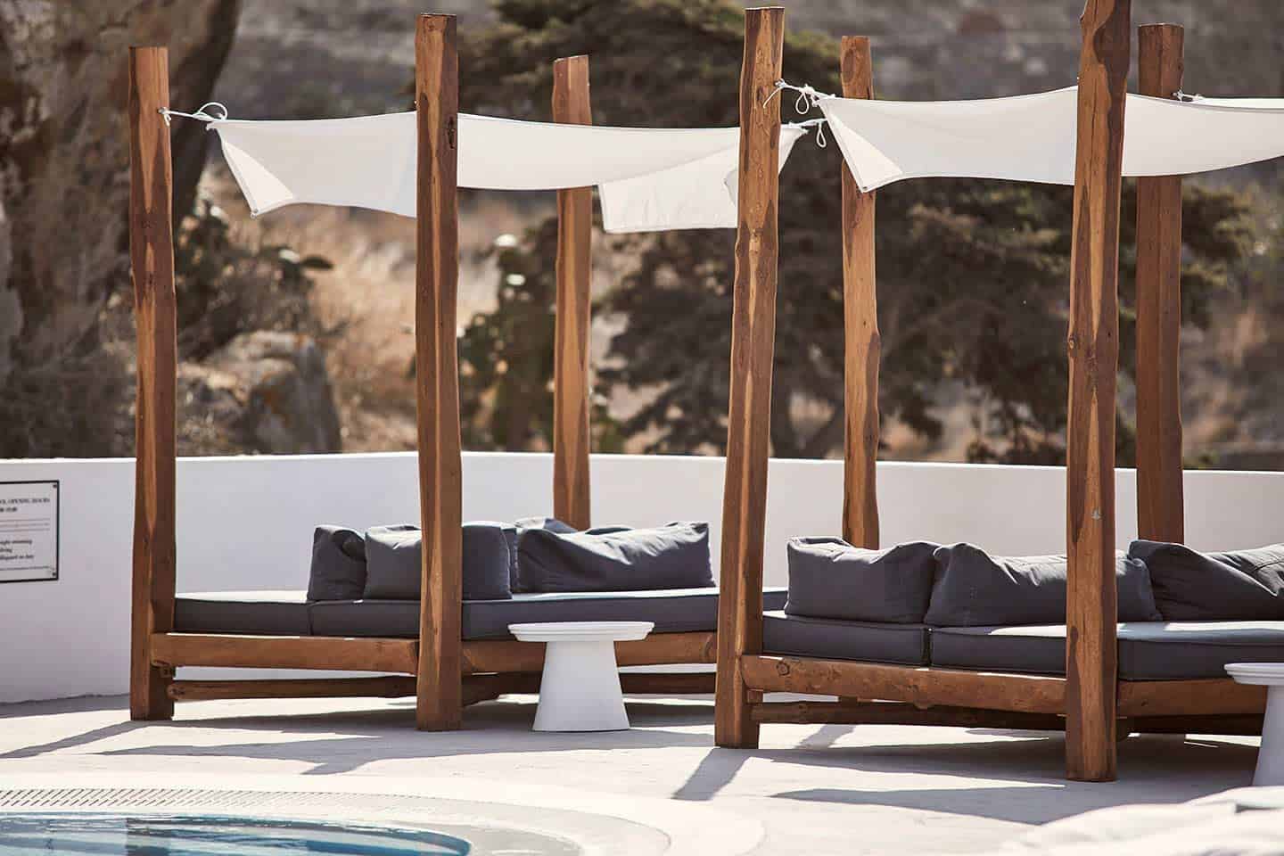Covered lounge furniture by the pool at Boheme Mykonos