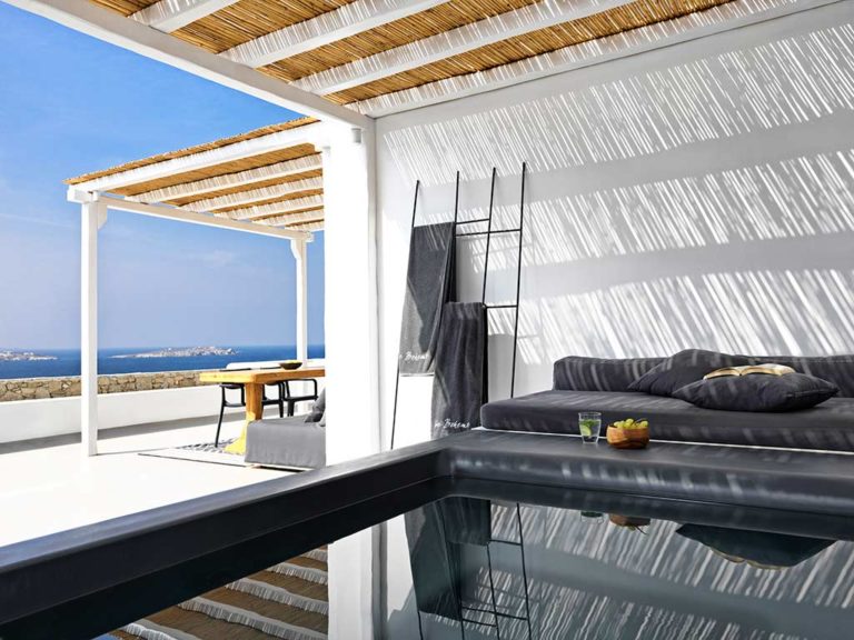 Boheme Mykonos - Bohemian Suite covered outdoor pool next to a seating area