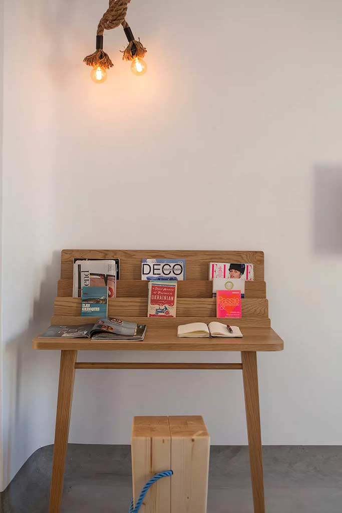Boheme Mykonos - Deluxe Suite workstation covered in reading materials