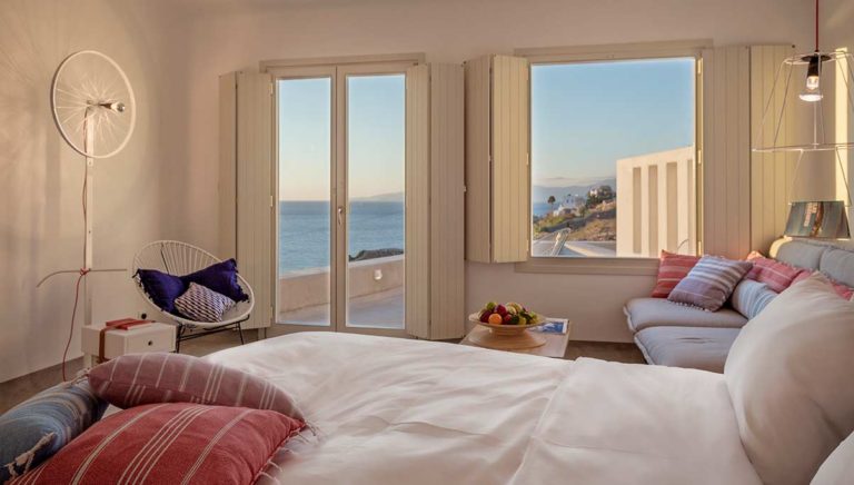 Boheme Mykonos - Superior Sea View Suite bed and sitting area with ocean view
